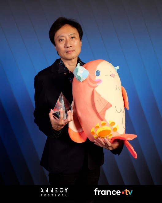 ChaO director Yasuhiro Aoki celebrates the Jury Prize win at Annecy 2025 with the creative team