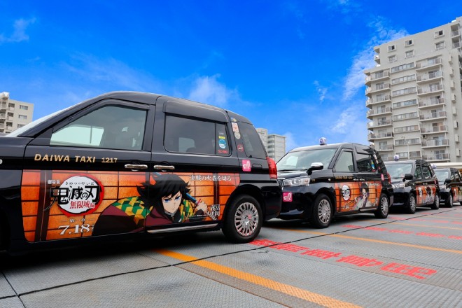 Demon Slayer wrapped taxi driving in Tokyo featuring main characters